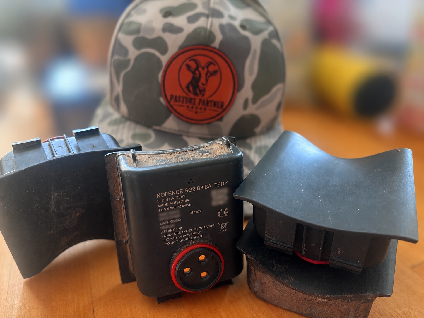 Pasture Partner Ranch hat with Nofence collar equipment and batteries
